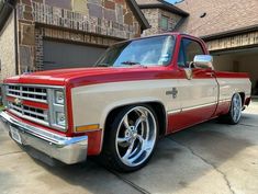 a red and white truck parked in front of a house