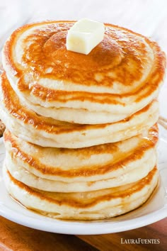 a stack of pancakes with butter on top