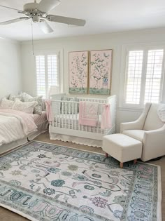 a baby's room with a crib, chair and rug