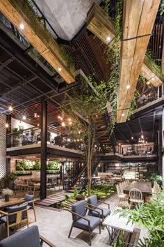 the interior of a restaurant with tables, chairs and potted plants on the walls