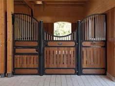 the inside of a horse stable with wooden doors