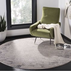 a green chair sitting on top of a round rug