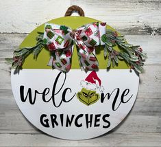 a sign that says welcome to the grinnies with bows on it and an ornament