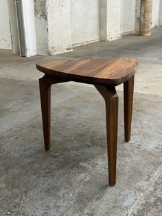 a wooden table sitting on top of a cement floor