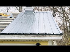 the roof of a house that has been gutted with metal shingles and a chimney