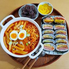 a bowl of ramen and other foods on a plate