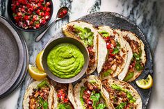 tacos with guacamole and salsa on the side