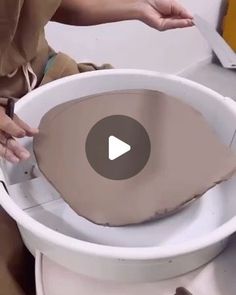 a person is using a device to clean a toilet bowl that has been placed on top of it