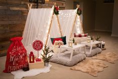 a living room decorated for christmas with lights and decorations on the walls, couches and tables