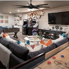 a living room filled with furniture and a flat screen tv mounted to the side of a wall