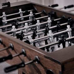 an old foosball table with wooden handles and black and white figurines