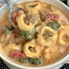 a white bowl filled with pasta and meat soup