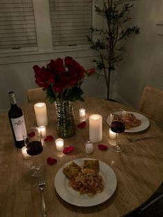 the table is set for valentine's day with wine and food