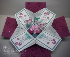 an origami card with flowers and butterflies on it