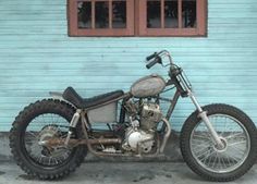 a motorcycle parked in front of a blue building