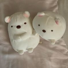 two white teddy bears sitting next to each other