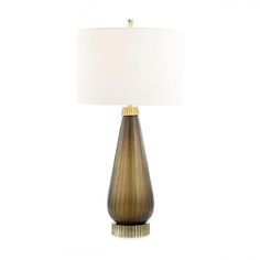 a table lamp with a white shade on it and a gold frame around the base