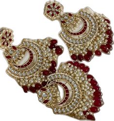 Heavy Red Jewelry For Puja, Diwali Red Kundan Tikka, Red Kundan Tikka For Diwali, Red Chandbalis For Festive Occasions, Red Chandbali Jewelry With Latkans, Red Chandbali Jewelry For Puja, Red Jhumkas With Latkans For Puja, Red Latkans Jhumkas For Puja, Traditional Red Tikka For Eid