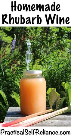 homemade rhubarb wine in a mason jar with strawberries next to it