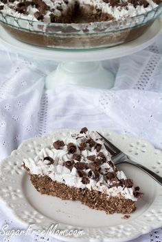 a piece of cake on a plate with a fork in front of it and the rest of the pie behind it