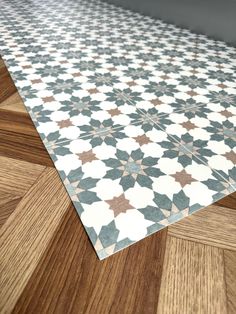 the floor is made up of wood and tile with star designs on it's sides