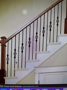 a cat sitting on top of a wooden bannister next to a stair case