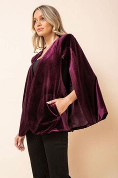 The Kari velvet cape jacket featuring should pads and side pockets can take any outfit from cute to kapow! Style It+ Finish the LookDress up a pair of jeans and a top or add to your favorite dress.Pair with strappy heels or consider boots/booties and a fun wool hat. Style FeaturesPocketsShoulder Pads Size + FitModel is 5`8" And Wearing Size Small Measurements Taken From Size Small Approx. Length: 27" FabricDetails Self: 97% Polyester 3% Spandex Lining: 100% Polyester Velvet Cape, Cape Jacket, Winter Capsule Wardrobe, Hat Style, Beach Skirt, Wool Hat, Favorite Dress, Strappy Heels, Holiday Outfits