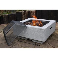 an outdoor fire pit sitting on top of a stone patio