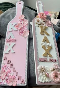 two pink and white bookmarks decorated with flowers on top of a stuffed animal's back