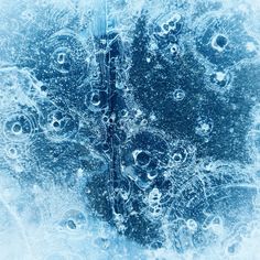 an abstract blue background with water bubbles and circles in the center, as well as other things that appear to be floating on ice