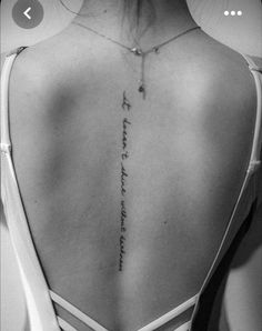 a woman with a cross tattoo on her back