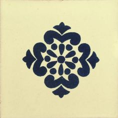 a blue and white tile with an ornate design on it's side, in the middle