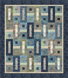 a blue and green quilt with squares on the front, one block in the middle