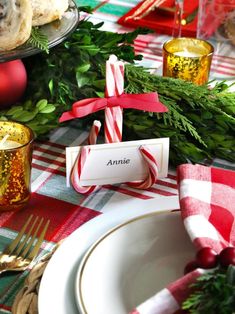 the table is set for christmas dinner with candy canes and other festive items