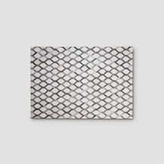 a white and grey tile with an abstract pattern on it's surface, in the shape of a diamond