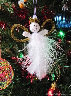 an angel ornament hanging from a christmas tree