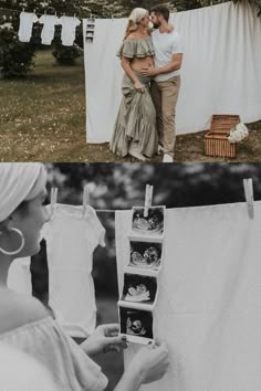 a couple standing next to each other in front of clothes hanging on a line with pictures