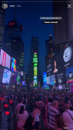 a large group of people standing in the middle of a city at night