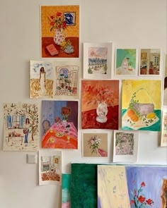 many paintings are hanging on the wall