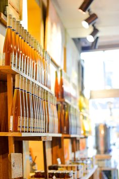 there are many bottles and plates on the shelves