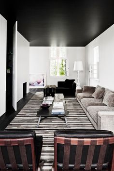 a living room with couches and chairs in it