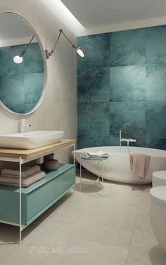 a bathroom with a tub, sink and mirror in it's center wall that has blue tiles on the walls