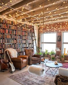 a living room filled with lots of furniture and bookshelves next to a window