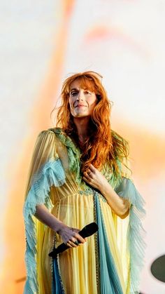 a woman with red hair wearing a yellow and blue dress