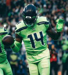 a football player is running with the ball in his hand and people are watching from the stands