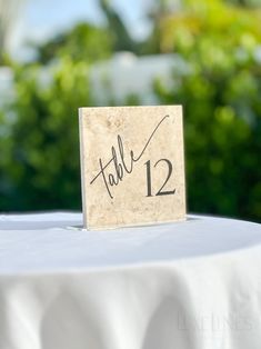 a table with a small wooden sign that says table 12