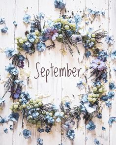 a wreath made out of flowers with the word september written on it