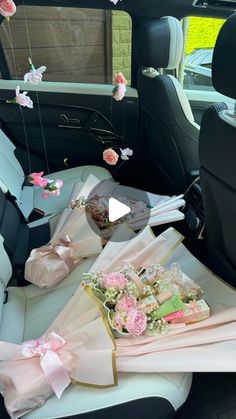 the back seat of a car with pink flowers and bows on it's side