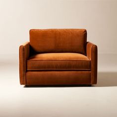 an orange couch sitting on top of a white floor