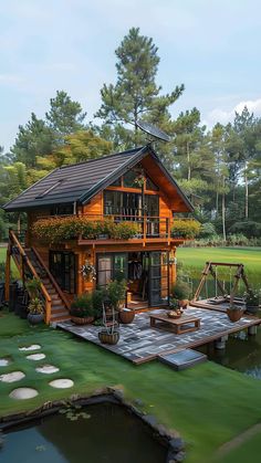 a small wooden house sitting on top of a lush green field next to a lake